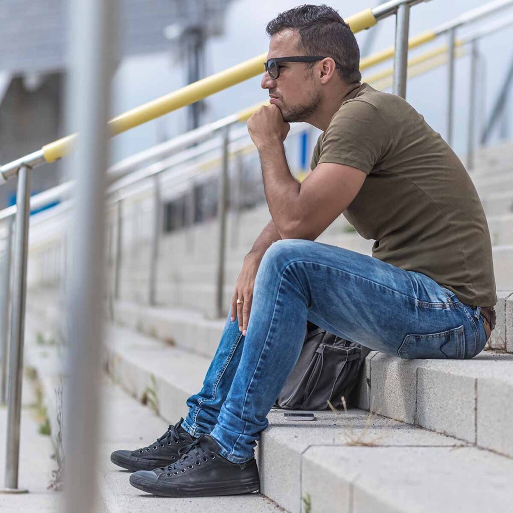 Young man sitting on steps outdoors