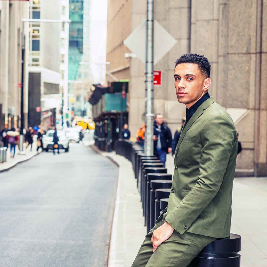 Young man standing on street corner
