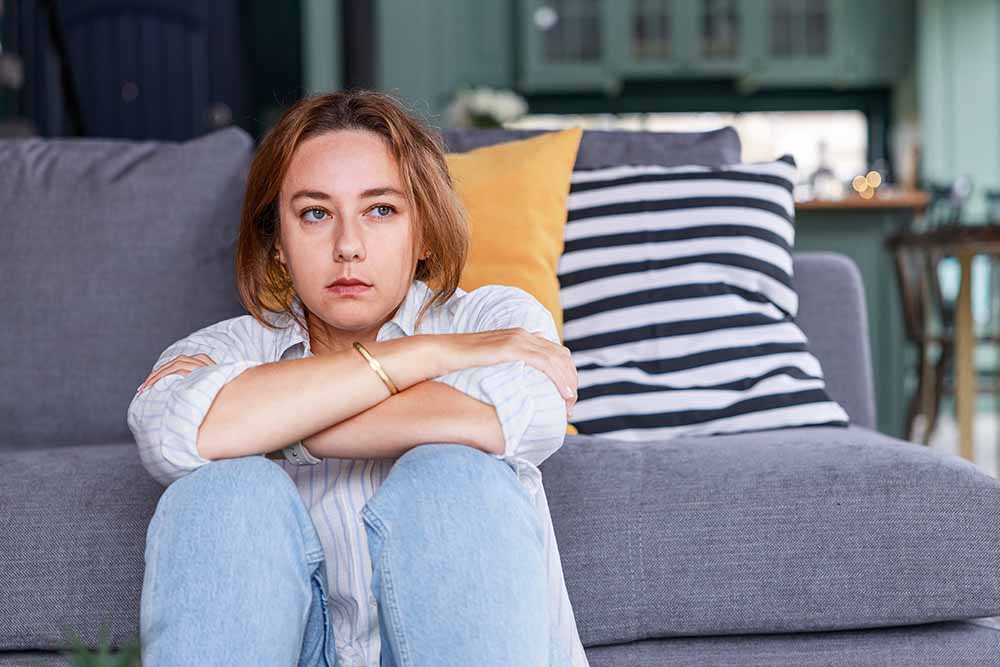 Young woman sitting in apartment