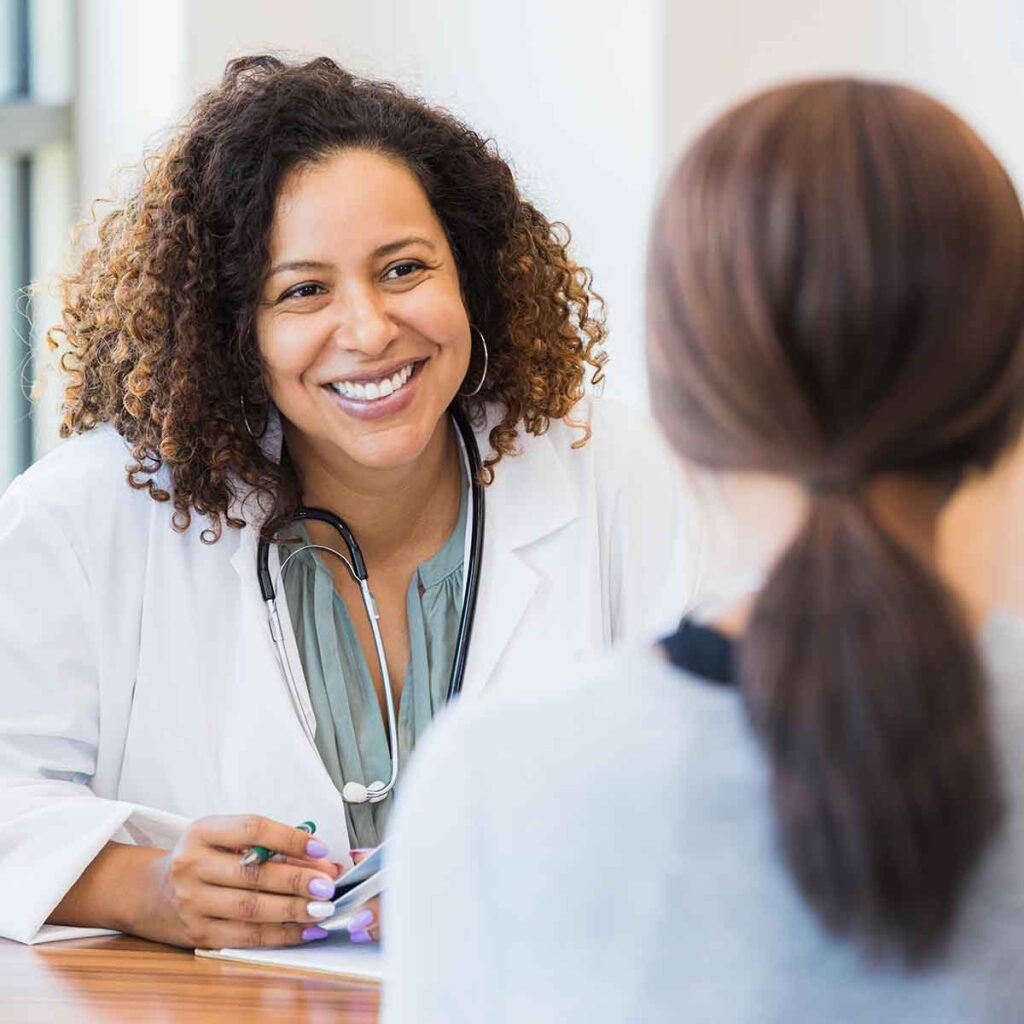 Woman doctor consulting with patient